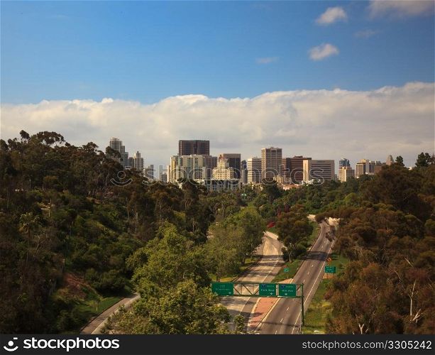 Unusual view of San Diego skyline off Cabrillo bridge from Balboa Park over empty interstate highway