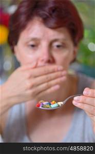 unwanted take pills woman holding spoon with pills