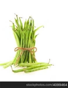 Unwashed green beans tied with cord on white background