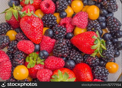 Up Close view of fresh berries of different types, all mixed together.