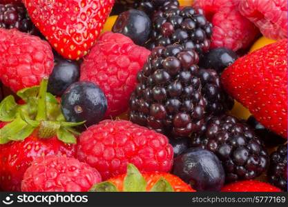 Up Close view of fresh berries of different types, all mixed together.