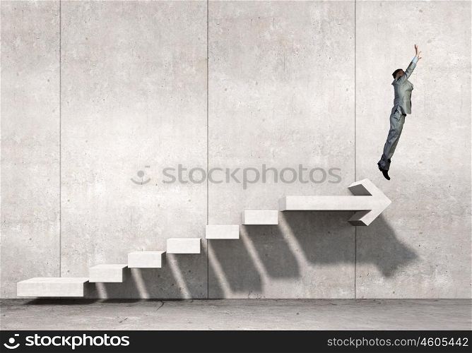 Up the career ladder. Businessman with suitcase jumping up stone staircase