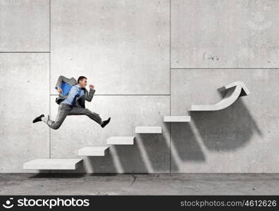 Up the career ladder. Businessman with suitcase running on stone staircase