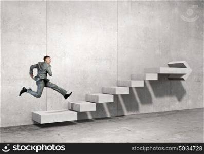 Up the career ladder. Businessman with suitcase running on stone staircase