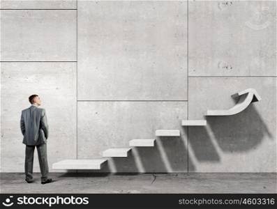 Up the career ladder. Businessman with suitcase stepping up stone staircase