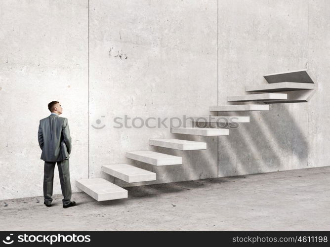 Up the career ladder. Businessman with suitcase stepping up stone staircase