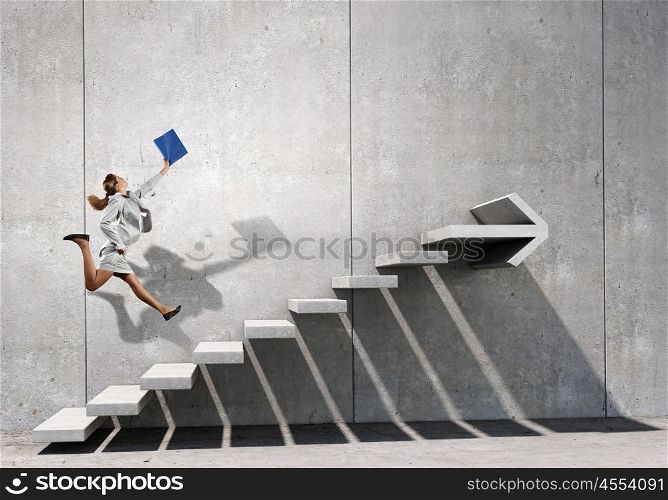 Up the career ladder. Businesswoman with suitcase running up stone staircase