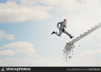 Up the career ladder overcoming challenges. Young businessman walking up collapsing staircase representing success concept