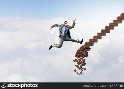 Up the career ladder overcoming challenges. Young businessman walking up collapsing staircase representing success concept