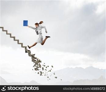 Up the career ladder overcoming challenges. Young businesswoman walking up collapsing staircase representing success concept