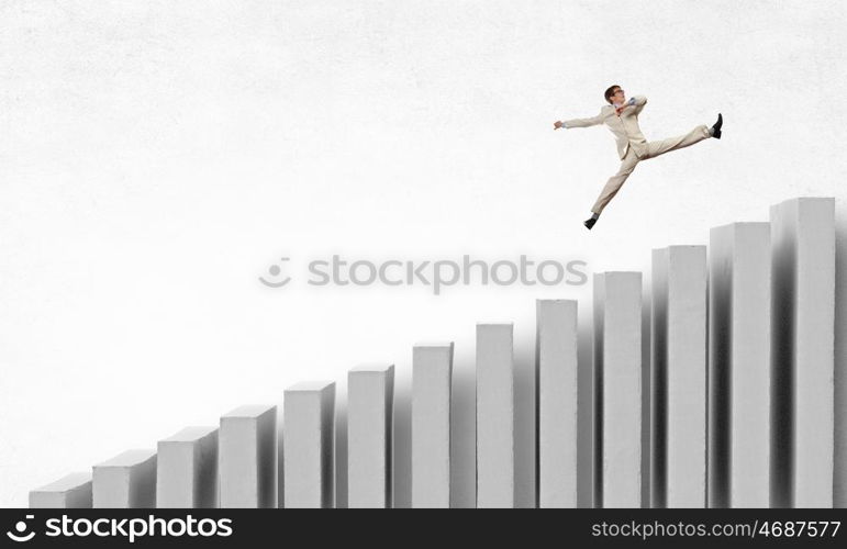 Up the career ladder. Young businessman running up on staircase representing success concept