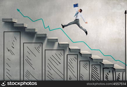 Up the career ladder. Young businessman walking up on staircase representing success concept