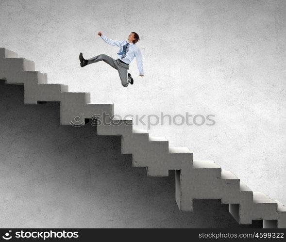 Up the career ladder. Young businessman walking up on staircase representing success concept