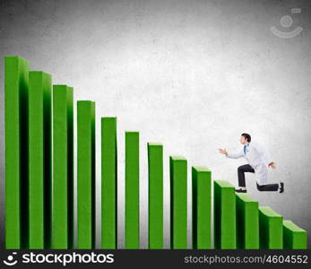 Up the career ladder. Young businessman walking up on staircase representing success concept