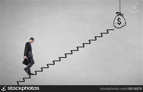 Up the career ladder. Young businessman walking up on staircase representing success concept