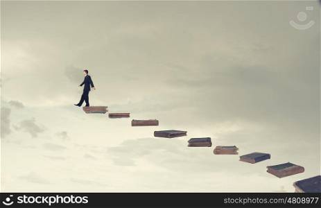 Up the career ladder. Young businessman walking up staircase representing success concept