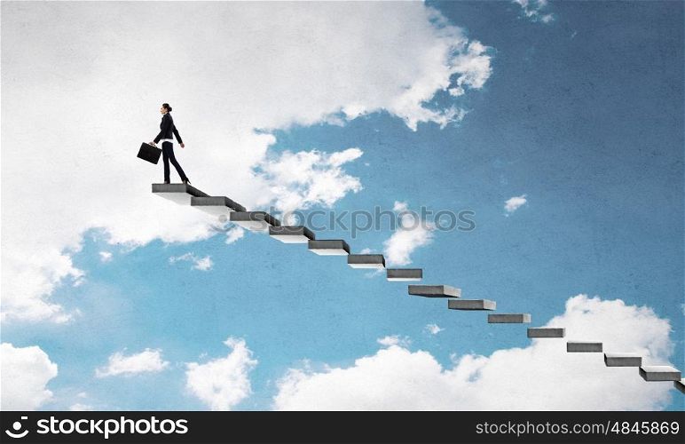 Up the career ladder. Young businesswoman walking up staircase representing success concept