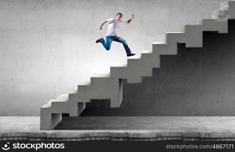 Up the career ladder. Young man walking up on staircase representing success concept