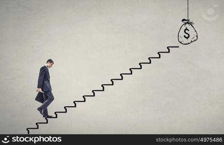 Up the career ladder. Young tired businessman walking up on staircase representing wealth concept