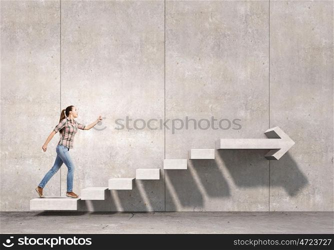 Up the staircase. Young girl in casual running on stone staircase