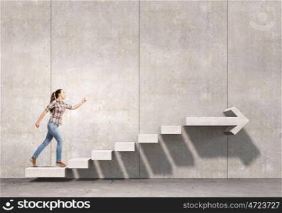 Up the staircase. Young girl in casual running on stone staircase