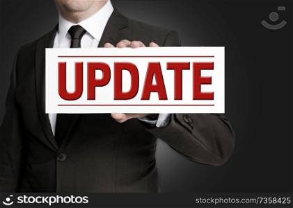 Update Terms of Use sign is held by businessman.. Update Terms of Use sign is held by businessman