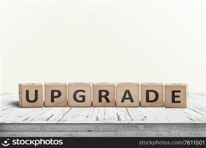 Upgrade sign made with wooden blocks on a worn table in a bright room