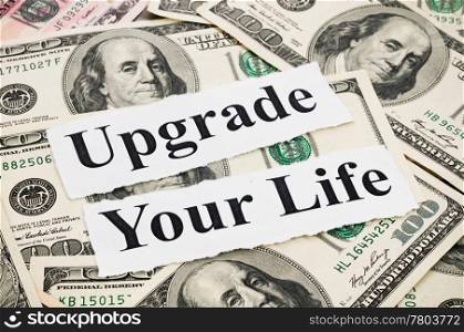 Upgrade your life by money, words on hundreds US notes background
