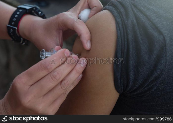 Upper arm vaccination, anti epidemic.