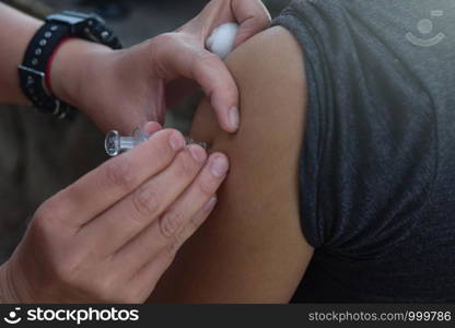 Upper arm vaccination, anti epidemic.