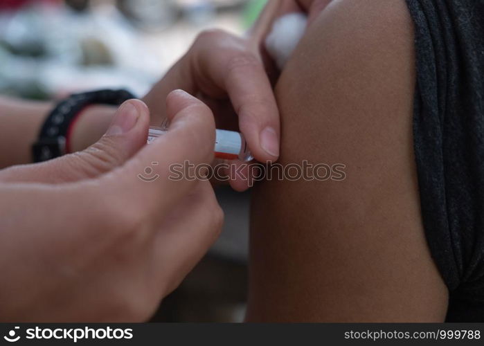 Upper arm vaccination, anti epidemic.