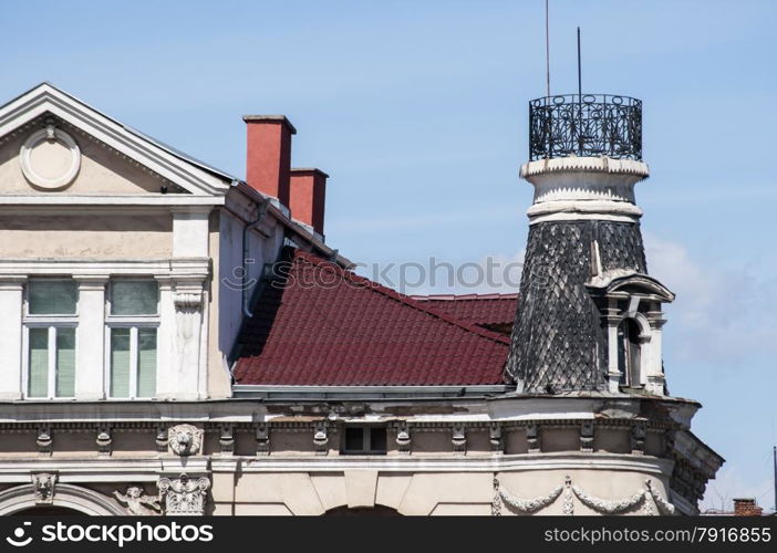 Upper part of the old town house on blue sky background