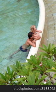 Upper view of couple in swimming-pool