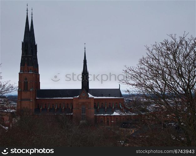 Uppsala cathedral. Cathedral of Uppsala, Sweden, in winter with trees in foreground