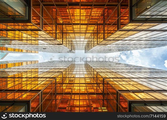 Uprisen angle of Hong Kong skyscraper with reflection of clouds among high building, Building glasses, business and financial, Architecture and industrial concept