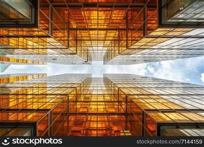 Uprisen angle of Hong Kong skyscraper with reflection of clouds among high building, Building glasses, business and financial, Architecture and industrial concept