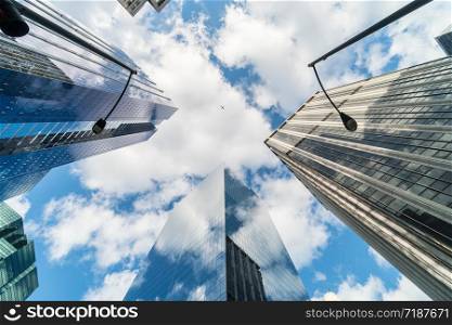 Uprisen angle scene of Downtown Chicago skyscraper with reflection of clouds among high buildings which have airplane flying over the sky, Illinois, United States, Business and Perspective concept