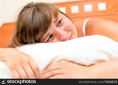 upset brunette crying in her bed