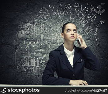 Upset businesswoman. Young upset businesswoman talking on mobile phone