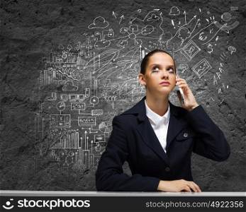 Upset businesswoman. Young upset businesswoman talking on mobile phone
