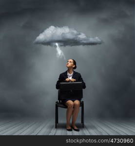 Upset businesswoman. Young upset businesswoman with suitcase sitting on chair