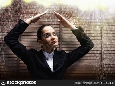 Upset businesswoman. Young upset crying businesswoman protecting head with arms