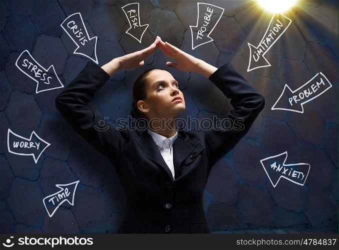 Upset businesswoman. Young upset crying businesswoman protecting head with arms