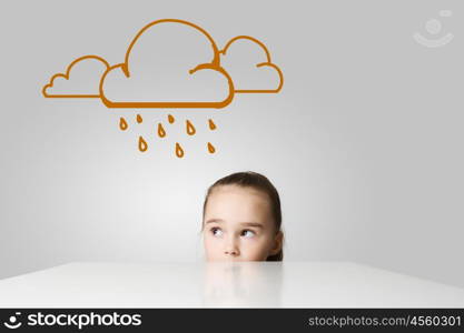 Upset girl. Little cute girl looking at raining cloud