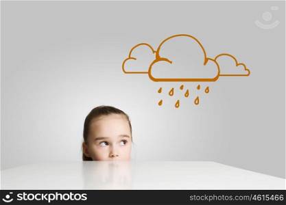 Upset girl. Little cute girl looking at raining cloud