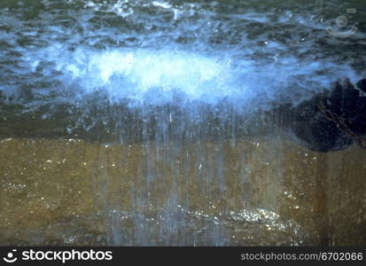 Upside down view of rain falling on the surface of water