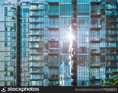 Urban abstract close up view of multiple steel and glass windows facade office building .