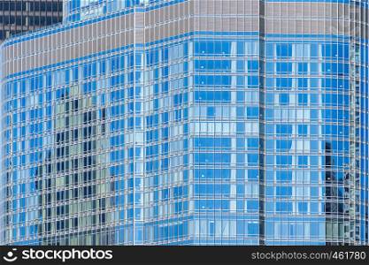 Urban abstract - window facade of business center office building with reflections and colours.