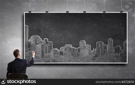 Urban architectural design. Rear view of businessman drawing construction project on banner