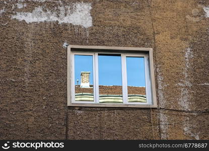 Urban building facade with window and reflections